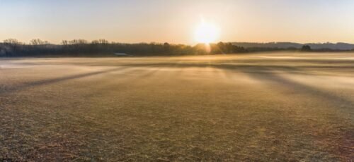 Beautiful foggy sunrise landscape in West Newton, Minnesota, USA, capturing autumn fields.