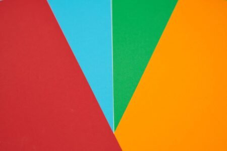 Colorful abstract design featuring red, blue, green, and orange geometric shapes.