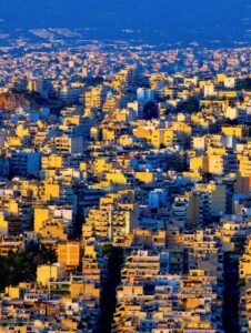 A stunning aerial view of Athens, Greece showcasing urban density at sunset.