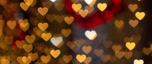 Warm and romantic heart-shaped bokeh lights creating a festive atmosphere. Perfect for Valentine's Day themes.