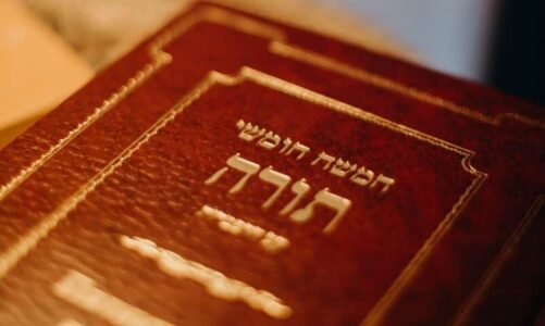 A close-up view of a Torah book with Hebrew text, symbolizing Jewish tradition and spirituality.
