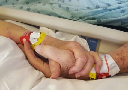 two persons holding hands