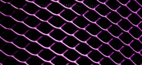 Close-up view of a purple illuminated metal grid pattern with a dark background.